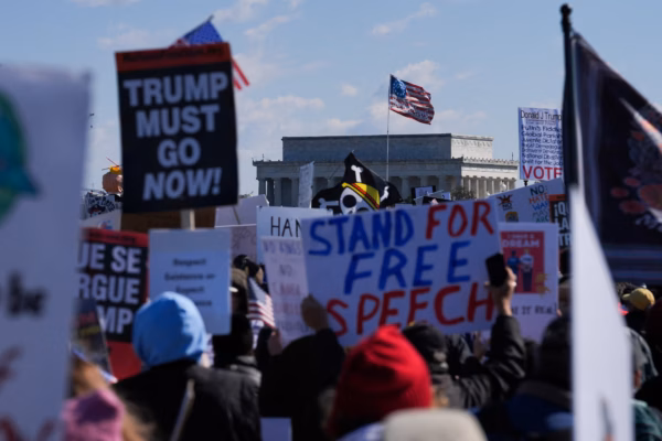 "We The People March For Freedom 2026" protest sign at an anti Trump rally.