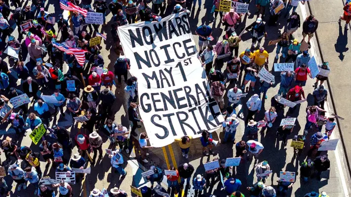 Nationwide May Day Protest 2026 crowd holding worker solidarity signs.